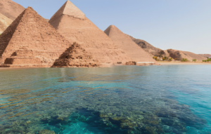 Edited picture of The great pyramids of Egypt and the shore of Sharm el sheikh, showing the transparent water of the red sea and coral reef